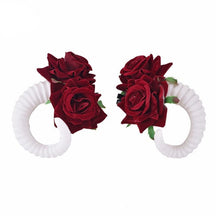 Curled ram horn hair clips with ridged detailing, available in black or white with plain or red rose designs