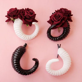 Curled ram horn hair clips with ridged detailing, available in black or white with plain or red rose designs