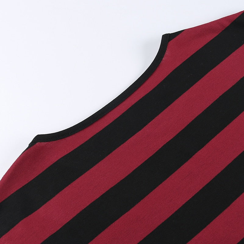 The curved back neckline and horizontal red-and-black stripes of the cropped sweater laid flat.