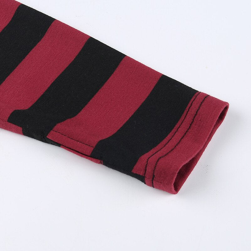 Close-up of the long sleeve's red-and-black striped cuff and its double stitched edge.