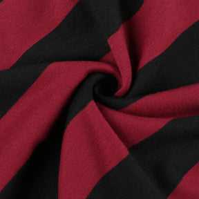 Close view of gathered red-and-black knit fabric showing the sweater's fine texture.