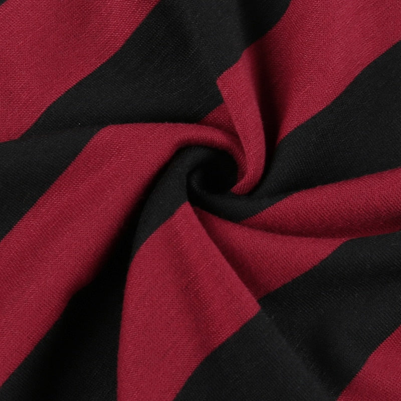 Close view of gathered red-and-black knit fabric showing the sweater's fine texture.