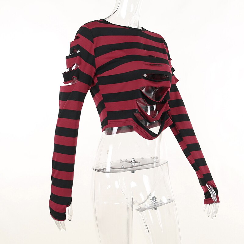 Angled mannequin view of the red and black striped crop sweater, showing the cutout front and upper sleeve openings.