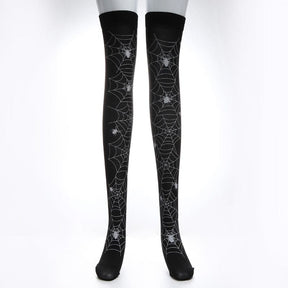 Black thigh-high stockings with pale spiderweb lines extending across the legs, isolated against white.