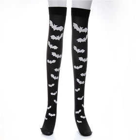 Black thigh-high stockings patterned with white bats, isolated against white.