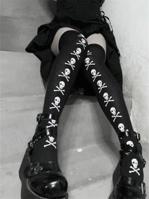Black thigh-high stockings with white skulls and crossbones arranged in vertical lines down the fronts, shown on steps.