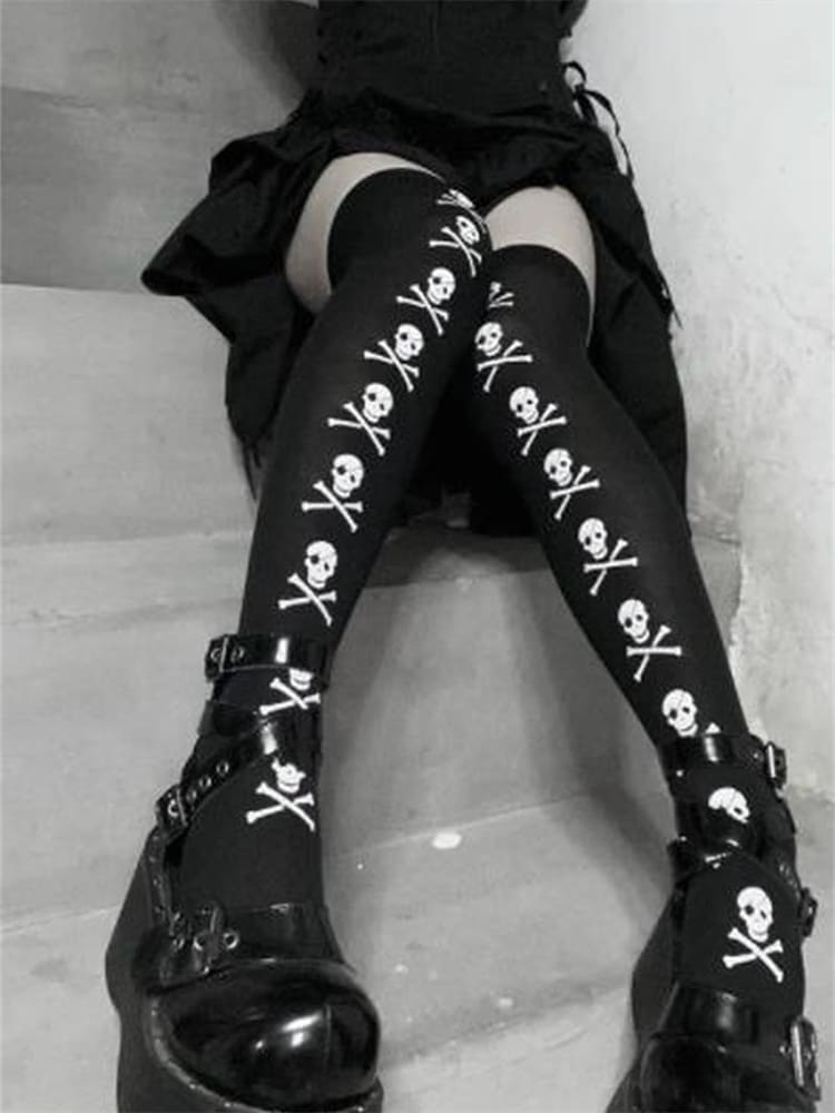 Black thigh-high stockings with white skulls and crossbones arranged in vertical lines down the fronts, shown on steps.