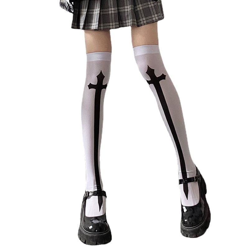 White thigh-high stockings with tall black crosses down the fronts, styled below a plaid hem.
