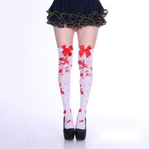 White thigh-high stockings with a red splatter print and large red bows.