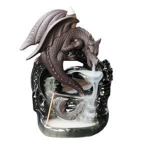 Dragon backflow incense burner isolated against white, with a gray curled dragon above the glossy black base and descending smoke channels.