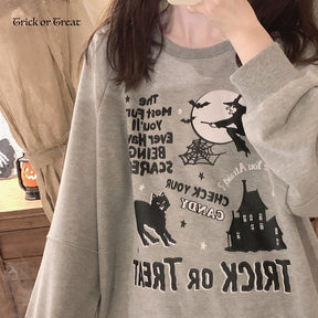 Close mirror view of the gray Trick or Treat graphic, showing the moon, witch, spiderweb and Halloween lettering beneath the crew neckline.
