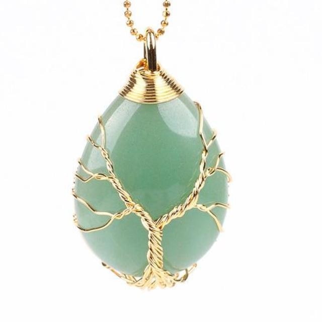 Green aventurine necklace with gold-tone tree wirework and a matching chain arranged beside the pendant.