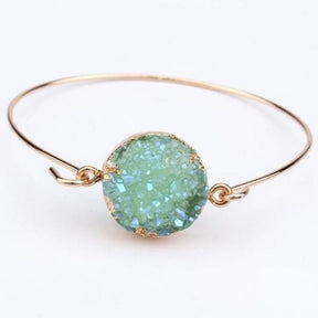 Green round druzy quartz cuff with a sparkling textured face and a thin gold-tone band.
