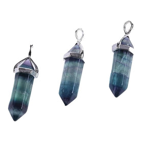 Three fluorite point pendants showing different balances of green and purple colour through their long faceted bodies.