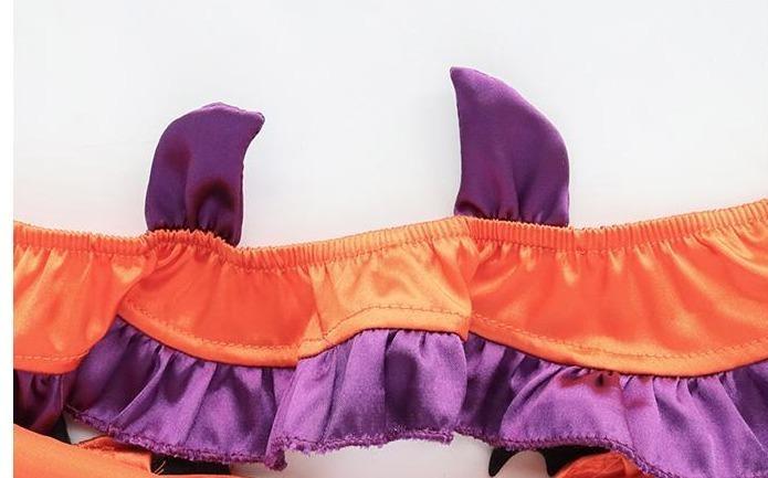 Close-up of the lingerie top's back band, showing two purple horn-shaped fabric accents above the gathered orange edge and purple ruffle.