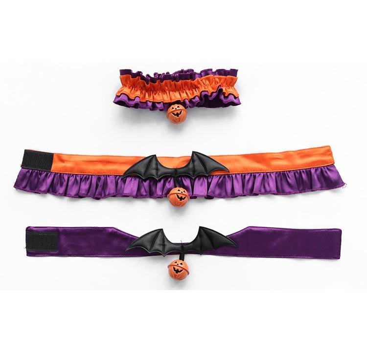 Three pumpkin chokers laid open in rows, showing their different purple and orange bands, ruffled edges and bat-wing decorations.