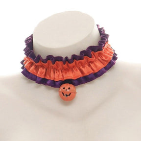 Orange Ruffles Halloween choker on a white bust, with gathered orange fabric, purple edging and a small orange pumpkin charm.