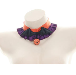 Front view of the orange-and-purple ruffled choker with black bat wings and a pumpkin charm against a white display bust.