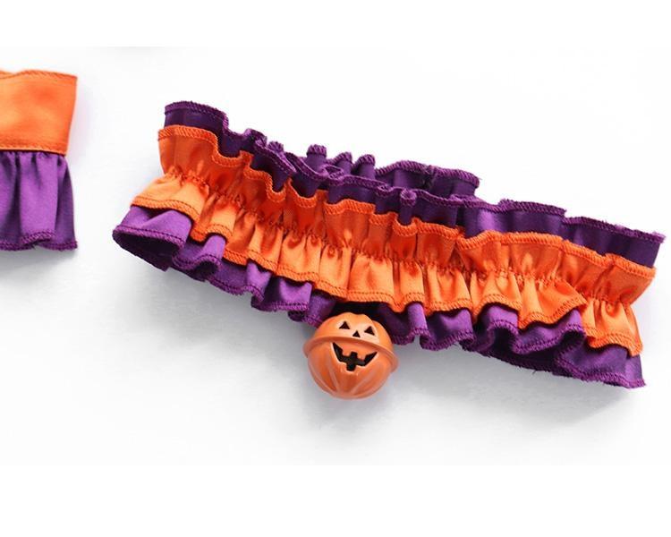 Gathered orange ruffle choker laid flat, showing the purple edge trim and small orange pumpkin charm at the front.
