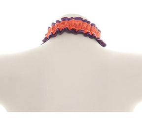 Rear view of the orange ruffled Halloween choker on a white display bust, showing how the purple-edged band wraps around the neck.