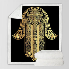 Full black and gold hamsa blanket design beside a folded view of the pale sherpa reverse.