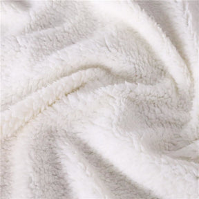 Close-up of the pale plush sherpa fleece texture on the reverse of the hamsa throw.