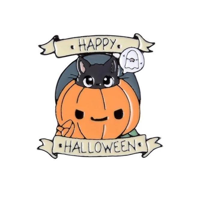 Happy Halloween enamel pin featuring a black cat peeking from an orange jack-o-lantern beside a small white ghost, framed by pale greeting banners.