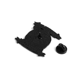 Reverse of the Happy Halloween enamel pin with a textured black back, central pin post and detached black rubber clutch against white.