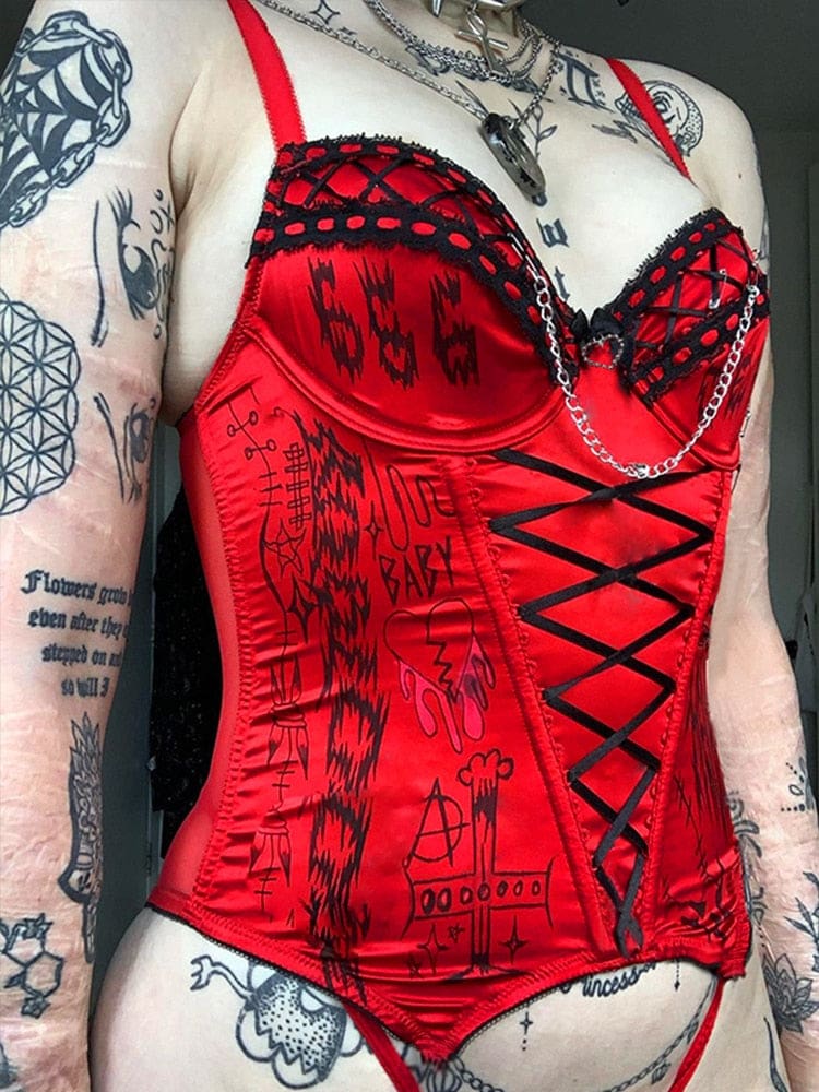 Angled view of the red Heartbreaker bustier, showing black crisscross cup details, a heart charm and the fitted printed front.