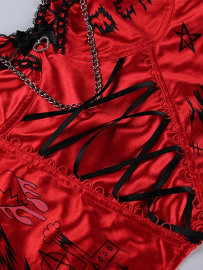 Flat close-up of red printed fabric, black crisscross ribbon and chain detailing on the Heartbreaker bustier.