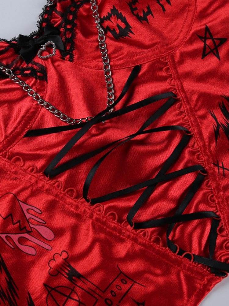 Flat close-up of red printed fabric, black crisscross ribbon and chain detailing on the Heartbreaker bustier.
