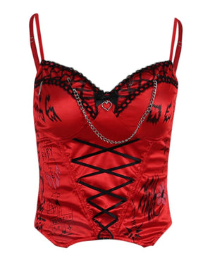 Red gothic bustier isolated against white, showing adjustable straps, black neckline trim, a heart charm and long front lacing.