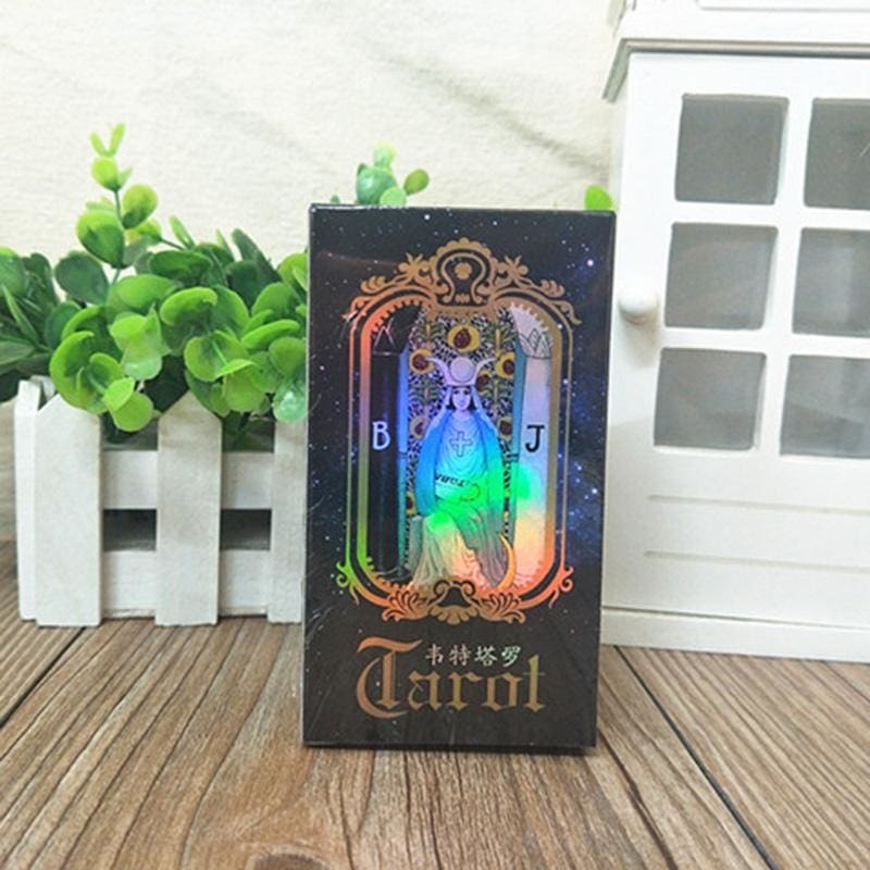 Upright black tarot deck box with reflective artwork on the front and a dark ornamental border.