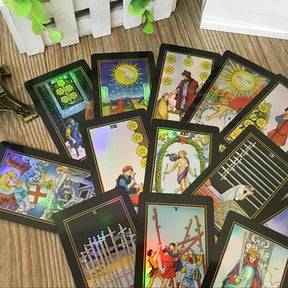 Holographic tarot cards scattered over a wooden surface, showing several illustrated faces at different angles.