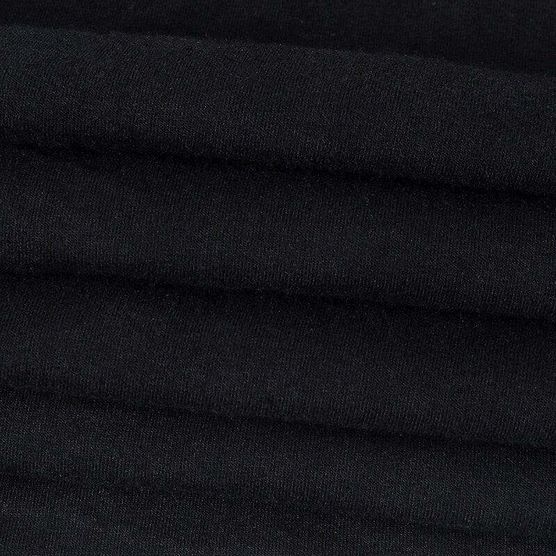 In Goth We Trust graphic T-shirt with a close view of the black fabric.