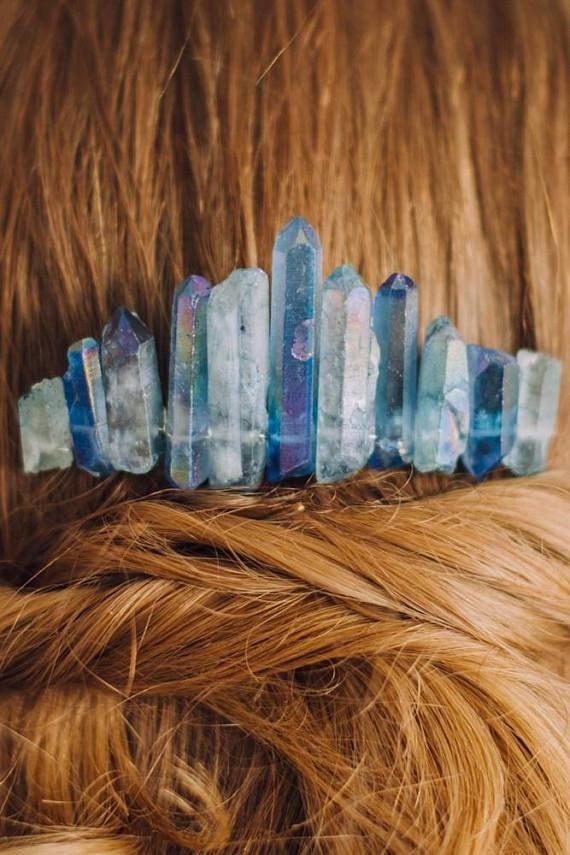 Vertical close-up of the blue crystal hair comb in a styled twist, showing the taller central points and shorter outer stones.