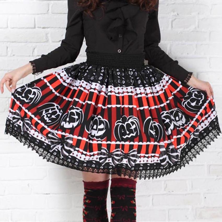 Red and black striped jack-o-lantern skirt held out to show its full shape, white pumpkin outlines and black lace hem. It is styled with a separate black blouse and patterned knee socks against a white brick wall.