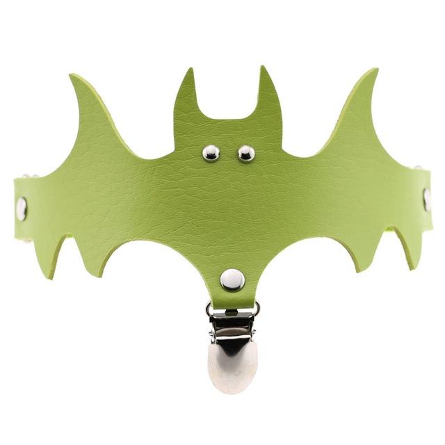 Lime green bat-shaped leg garter with small metallic eye details and a central hanging clip.