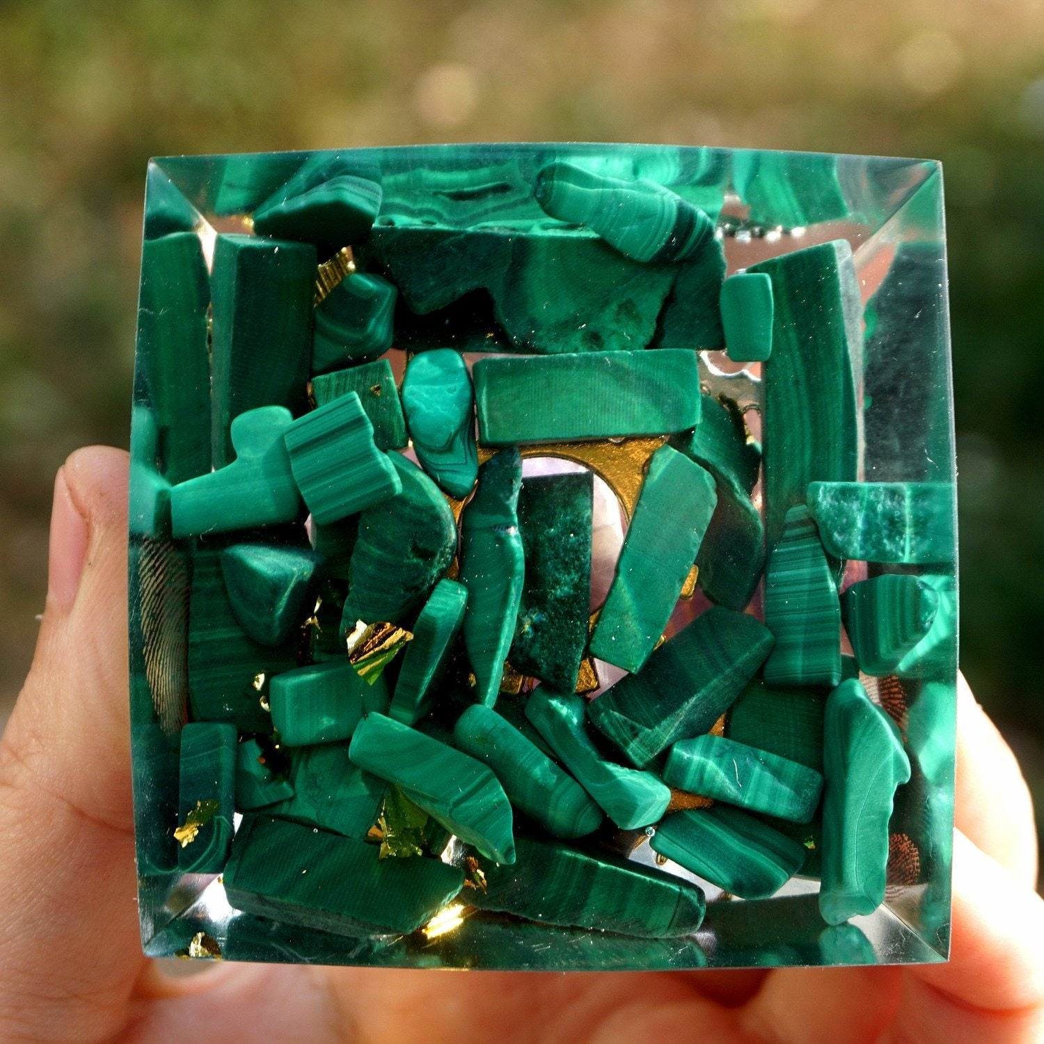 Square underside of the malachite and amethyst pyramid, filled with green stone pieces and bright metallic flecks.