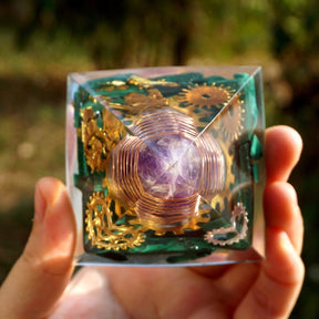 Overhead view through the pointed pyramid, showing green malachite pieces around the wrapped amethyst centre.