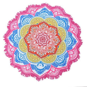 Pink-edged mandala flower throw with orange, yellow and blue petal rings radiating from the centre.