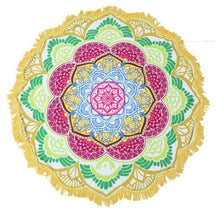 Full view of the yellow-and-green mandala throw, with a pink central flower, blue inner rings and white fringe around the outside.