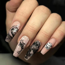 Long squared press-on nails with black-and-white manga-inspired portraits, fish, wave patterns and decorative lettering over pale pink bases.