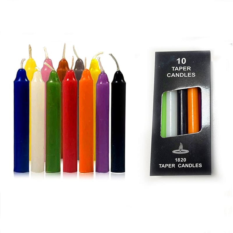 Assorted coloured ritual candles arranged upright beside a box, comparing bright, pale and dark shades.