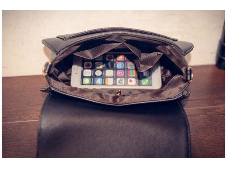 Top view inside the open moon cat bag, showing brown lining and an inner pocket with a phone used as a display prop.
