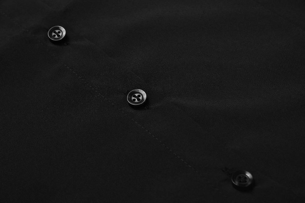 Close detail of black buttons and stitching along the Moon Child blouse’s front placket.
