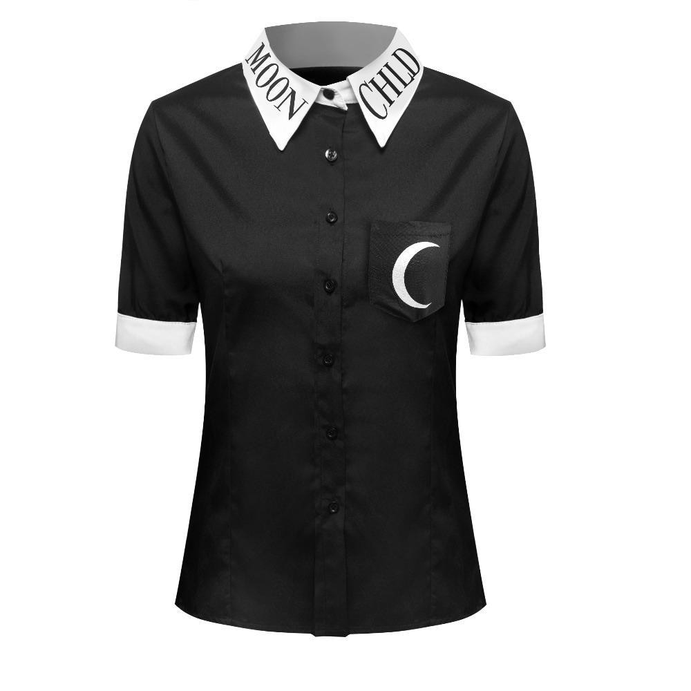 Front view of the black Moon Child short-sleeve blouse on a white torso form, with black buttons, a white lettered collar and a crescent moon chest pocket.