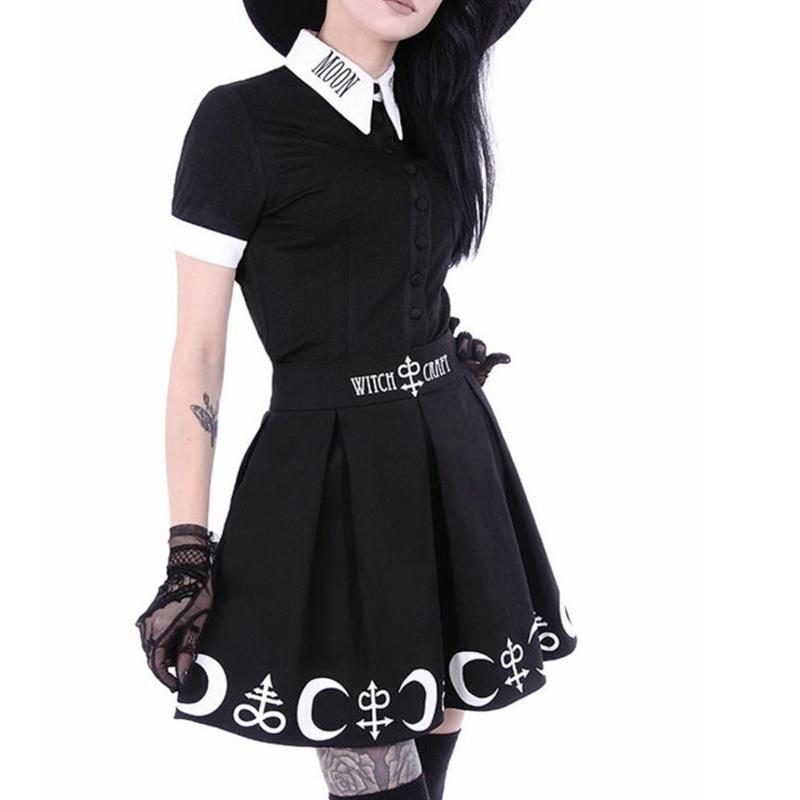 Black Moon Child blouse worn tucked into a separate black symbol-print skirt. The white pointed collar and sleeve cuffs contrast with the short sleeves and black button front.