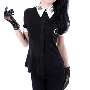 Front view of the black Moon Child blouse styled with separate lace gloves, highlighting the crescent chest pocket, white pointed collar and matching cuffs.
