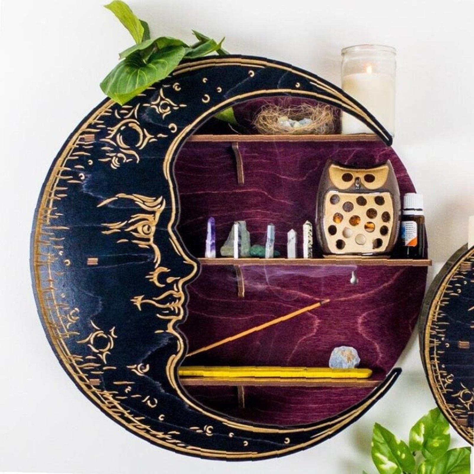 Purple moon shelf styled on a wall